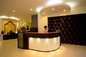 a woman sitting at a counter in a lobby at Royal Nakara Ao Nang in Ao Nang Beach