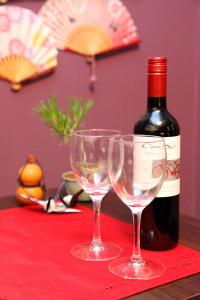 a bottle of wine and two wine glasses on a table at Hotel Neo World in Osaka