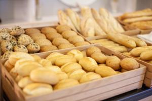 a bunch of different types of bread in trays at Grupotel Playa Club in Son Xoriguer