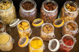 a group of jars filled with different types of food at Grupotel Playa Club in Son Xoriguer