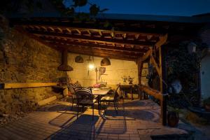 a patio with a table and chairs under a wooden pergola at Apartmán Antonínská in Znojmo