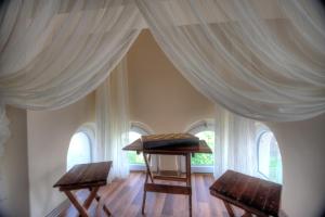 a room with two chairs and a table with curtains at Oban Suites Istanbul in Istanbul