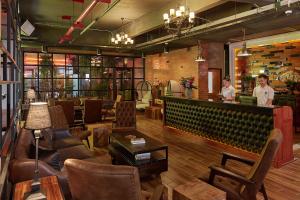 a restaurant with a bar with people standing behind the counter at W22 by Burasari in Bangkok