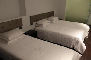 Postel nebo postele na pokoji v ubytování Lazza Hotel