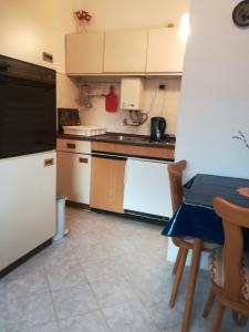 a kitchen with a white refrigerator and a table at Apartmani Parlov in Vinišće +30 photos