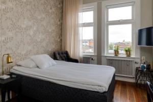 a hotel room with a bed and a window at Grand Hotel Jönköping in Jönköping