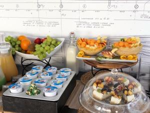 two trays of food with fruits and vegetables on them at Riva 33 in Porto Cesareo