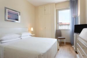 Postel nebo postele na pokoji v ubytování Hotel Sina Astor