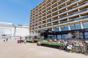 
a large building with a lot of people walking around at C-Hotels Andromeda in Ostend
