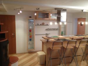 a kitchen with a bar with stools in it at Haus Nordlicht in Helgoland