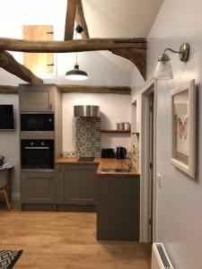 a kitchen with a sink and a stove at Rivers Rest in Norwich
