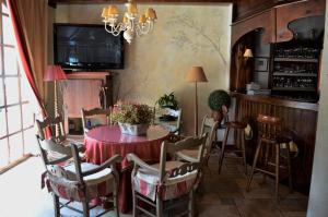 a dining room with a red table and chairs at Hotel Bocalé in Sallent de Gállego