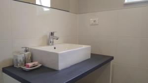 a bathroom with a white sink on a counter at Apartment Skavo in Baška Voda +9 photos