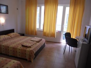 Postel nebo postele na pokoji v ubytování Guest House "Tania" + 6 fotografií