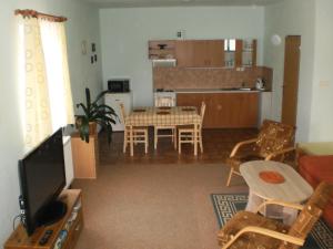 a living room with a table and a dining room at Apartman Kublovi in Vimperk