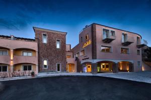 a large building with a pool in front of it at Grand Hotel Resort&SPA Ma&Ma - Adults Only in La Maddalena