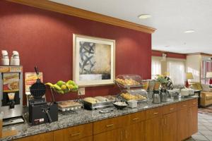 a kitchen with a buffet of food on a counter at Baymont by Wyndham Evansville North/Haubstadt in Haubstadt