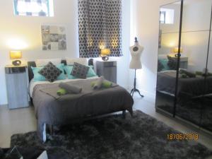 a bedroom with a bed and a large mirror at TESS Villa Fournadin in Fournaudin +30 photos