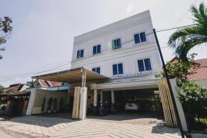 a large white building with a lot of windows at RedDoorz near Hermes Place Polonia Medan in Medan