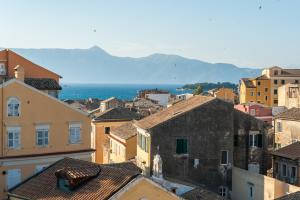 a view of a city with buildings and the ocean at Corfu Overview Penthouse in Corfu