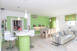 a kitchen and living room with a table and chairs at Corfu Overview Penthouse in Corfu