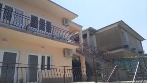 a building with stairs and balconies on it at Apartment Skavo in Baška Voda