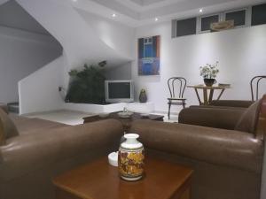 a living room with a couch and a table at Araliki Apartments & Studios in Loutra Edipsou