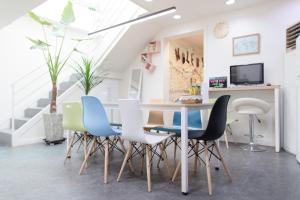 a dining room with a table and chairs at Nol Guesthouse in Busan