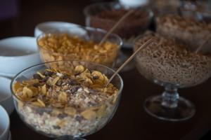 a table topped with bowls of food and wine glasses at Vila Galé Estoril in Estoril