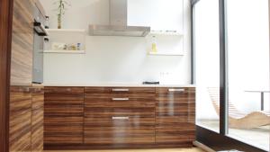 a kitchen with wooden drawers and a stove at Five Elements Hostel Leipzig in Leipzig +48 photos