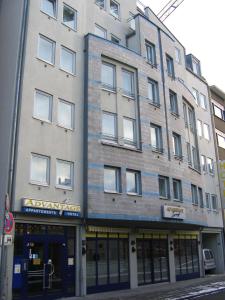 a tall building on the corner of a street at Advantage Appartements Hotel in Nürnberg