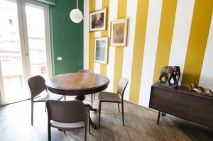 a dining room with a wooden table and chairs at ApartmentsGarda - Residenza Antiche Mura in Garda