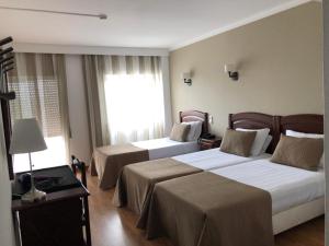 Postel nebo postele na pokoji v ubytování Hotel Paiva