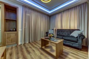 ein Wohnzimmer mit einem Sofa und einem Tisch in der Unterkunft Premium Hotel in Sankt Petersburg