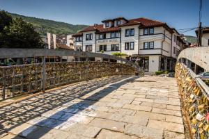 a bridge over a street with buildings in the background at Classic Hotel Prizren in Prizren