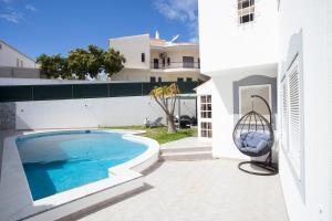 a swimming pool in the backyard of a house at Villa Monaco in Faro