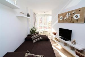 a living room with a couch and a tv at Coblanca 5 83 in Benidorm