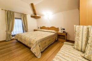 a bedroom with two beds and a window at Appartamenti Al Bivio in Imer