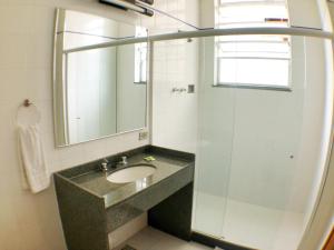 a bathroom with a sink and a mirror at Itajubá Hotel in Rio de Janeiro +33 photos