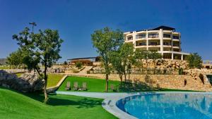 a resort with a swimming pool and a building at SL Panorama in Trebinje