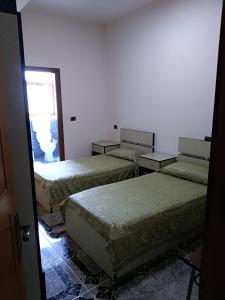 Postel nebo postele na pokoji v ubytování Hotel Gjeli