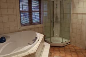 a white bathroom with a tub and a shower at Skipperhus Skjærhalden in Skjærhollen +18 photos