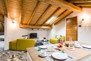a dining room with a table and yellow chairs at Casa Vacanza Etna Dream in Zafferana Etnea