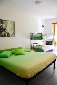 a bedroom with two bunk beds with green sheets at B&B Zia Vivina in Sorico