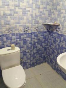 a bathroom with a toilet and a sink at Guest House TiAni in Kobuleti