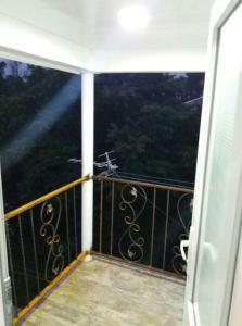 a balcony with a view of a forest at Guest House TiAni in Kobuleti