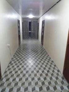 a hallway with a checkered floor in a building at Guest House TiAni in Kobuleti