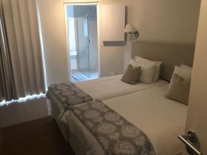 una camera d'albergo con un letto e una porta per un corridoio di 7a Clifton Steps a Città del Capo