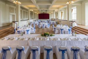 a set up for a wedding in a hall with tables and chairs at Cumbria Grand Hotel in Grange Over Sands +52 photos