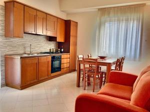 a kitchen and dining room with a table and chairs at Casa Vacanza nel cuore di Castellammare del golfo in Castellammare del Golfo